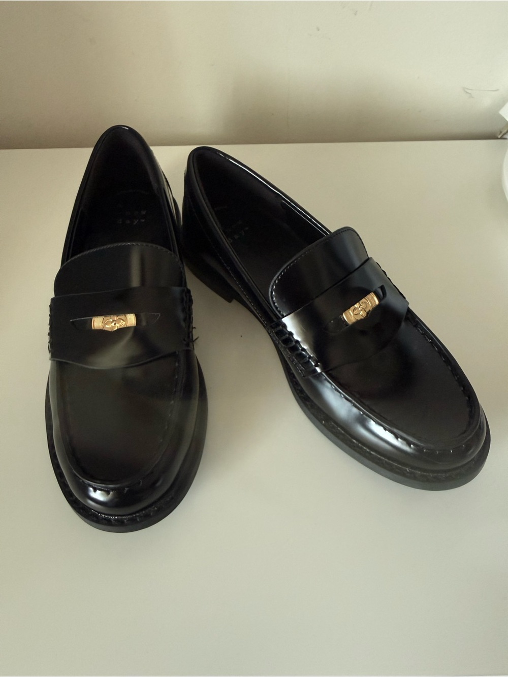 a new day Black Slip-On Penny Loafers with Gold Accent